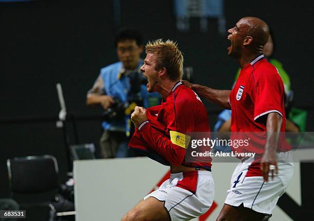 David Beckham of England celebrates after scoring the opening goal during the England v Argentina, Group F, World Cup Group Stage match played at the...