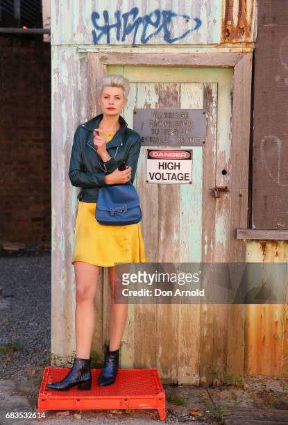 Kate Peck wearing Hansen and Gretel dress and jacket, shoes from Midas, boots from Midas, bag from Tod's, and sunglasses from Local Supply during...
