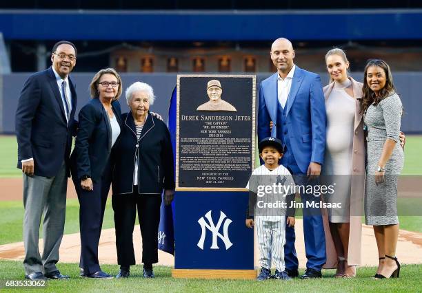 Derek Jeter poses with his Monument Park plaque with, from left, father Charles, mother Dorothy, grandmother Dot, nephew Jalen, wife Hannah and...