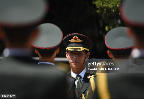 Members of a Chinese military honour guard prepare for a welcome ceremony for Cambodia's Prime Minister Hun Sen outside the Great Hall of the People...