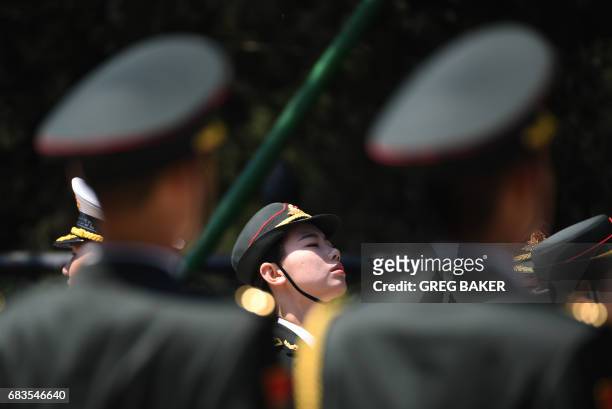 Members of a Chinese military honour guard prepare for a welcome ceremony for Cambodia's Prime Minister Hun Sen outside the Great Hall of the People...
