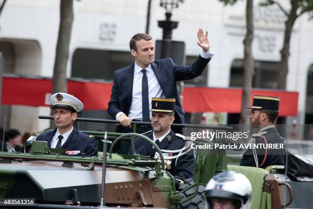 French President Emmanuel Macron greets the crowd on the avenue des Champs-Elysées after attending a ceremony at the Arc of Triomphe monument on May...