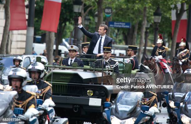 French President Emmanuel Macron greets the crowd on the avenue des Champs-Elysées after attending a ceremony at the Arc of Triomphe monument on May...