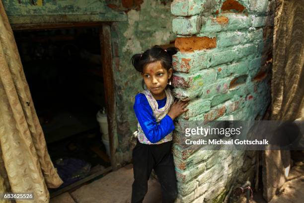 Dehli, India A girl at the entrance of an apartment in the slum of the city district Seemapuri, where the Caritas and the NGO Chentanalaya support...