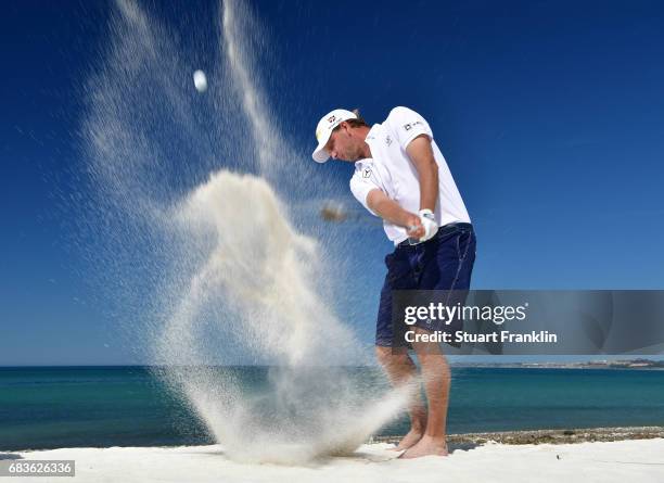 Marcel Siem of Germany plays a shot on the beach prior to the start of The Rocco Forte Open at Verdura Golf and Spa Resort on May 16, 2017 in...