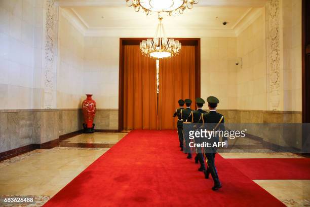 Uniformed guards march inside the Great Hall of the People where China's President and Prime Minister were meeting visiting leaders in Beijing in...