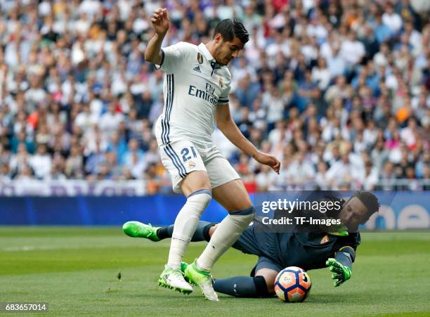 Alvaro Morata and Sergio Rico of Sevilla battle for the ball during the La Liga match between Real Madrid CF and Sevilla CF at Estadio Santiago...