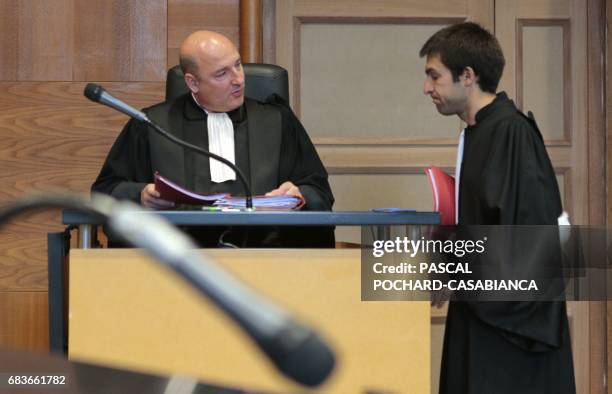 Bastia's prosecutor Nicolas Bessone speaks with a lawyer at the Bastia's court house on May 16, 2017 during the second day of the trial of Bastia's...