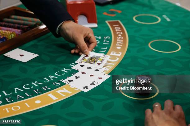 Cards are dealt on a Blackjack table at the Global Gaming Expo inside the Venetian Macau resort and casino, operated by Sands China Ltd., a unit of...