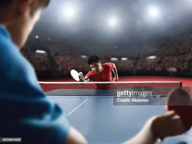 two ping pong players play table tennis - table tennis stock pictures, royalty-free photos & images