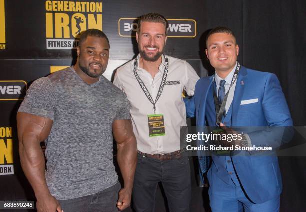 Professional bodybuilder Brandon Curry poses with Executive Producer Ollie Upton and Dr. Jacob Wilson as he arrives to attend the premiere of...