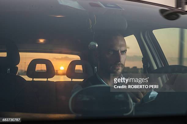 businessman driving car on coast at sunset, cagliari, sardinia, italy - hunky guy on beach stock pictures, royalty-free photos & images
