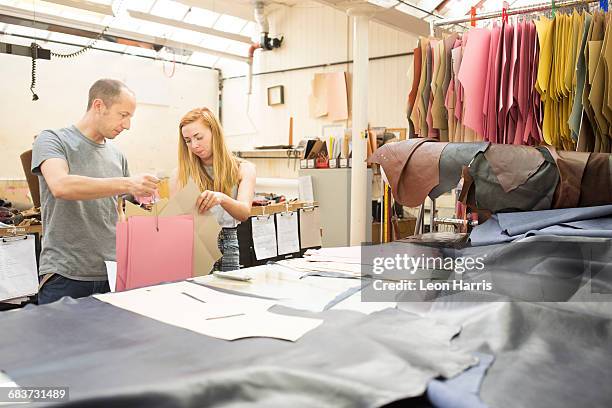 man and woman having discussion in leather jacket manufacturers - leather industry stock pictures, royalty-free photos & images