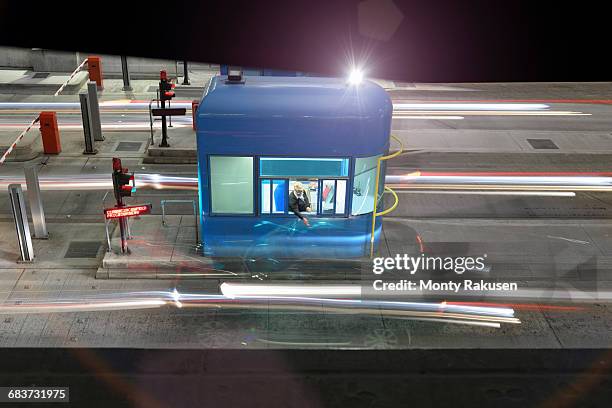 night view of cars passing through toll booth at bridge, high angle - toll stock pictures, royalty-free photos & images