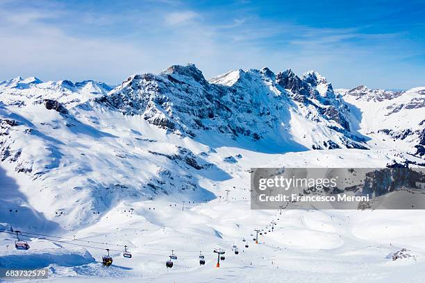 snow covered mountain landscape and ski lift, engelberg, mount titlis, switzerland - ski resort stock pictures, royalty-free photos & images