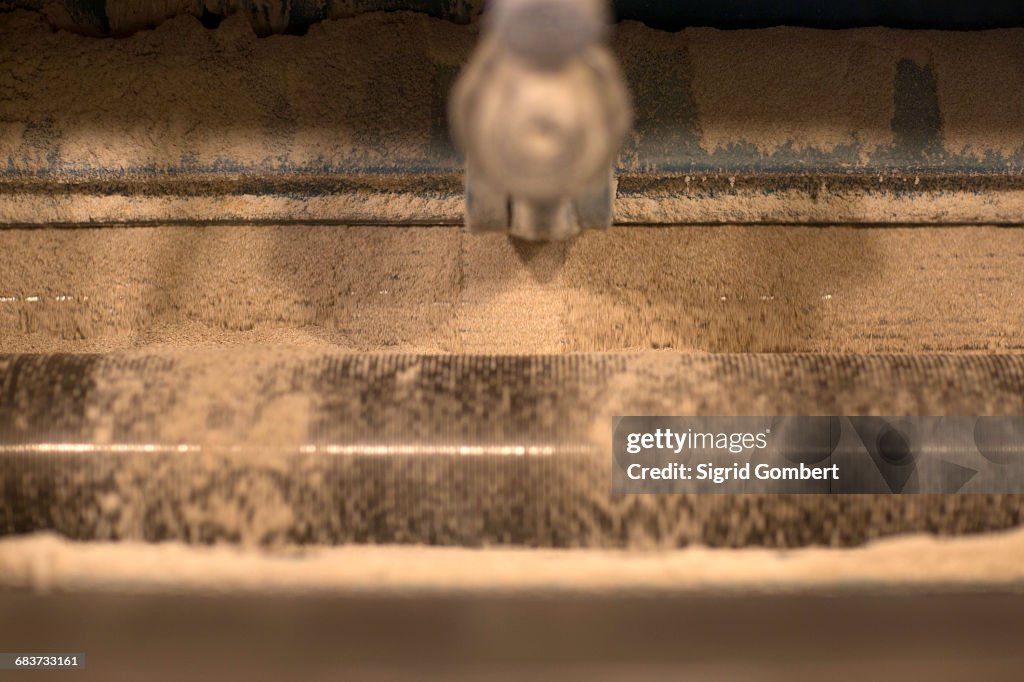 Close up of grinding machine at wheat mill