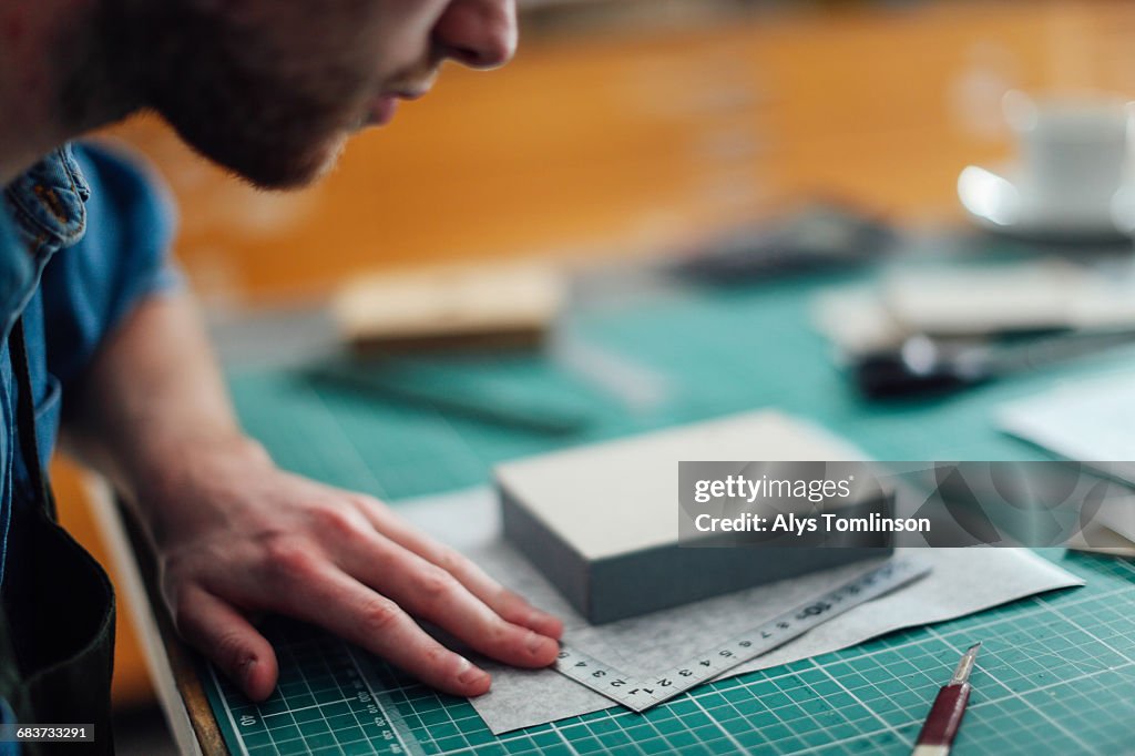 Young man working in print studio, close-up