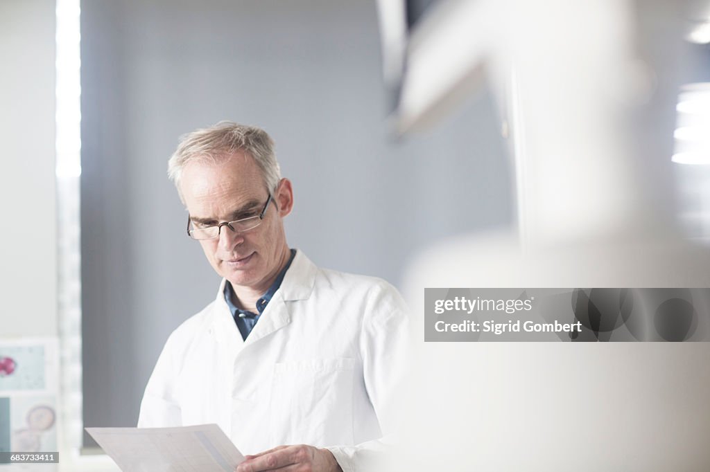 Male meteorologist reading data in weather station laboratory