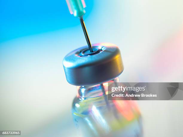 syringe inserted into a vaccine vial - medicinflaska bildbanksfoton och bilder