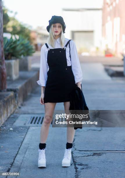 Model wearing a white button shirt, hat, black dress at day 3 during Mercedes-Benz Fashion Week Resort 18 Collections at Carriageworks on May 16,...