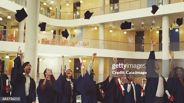 college graduates throwing cap - animated graduation cap stock pictures, royalty-free photos & images