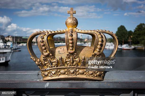 golden crown on skeppsholm bridge, stockholm, sweden - crown headwear stock pictures, royalty-free photos & images