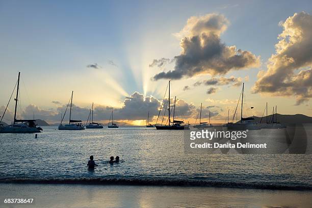kids playing in water at cane garden bay, tortola, british virgin islands - cane garden bay stock pictures, royalty-free photos & images