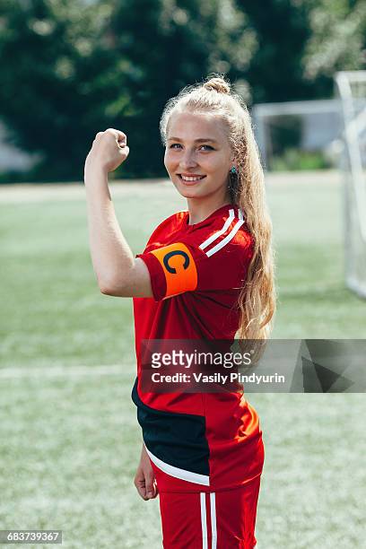 confident soccer captain showing band with letter c on field - skipper stock pictures, royalty-free photos & images