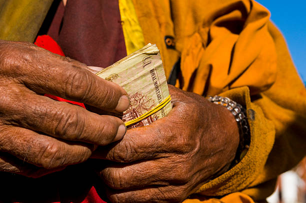 monk holding money, paro, bhutan - bhutan currency stock pictures, royalty-free photos & images