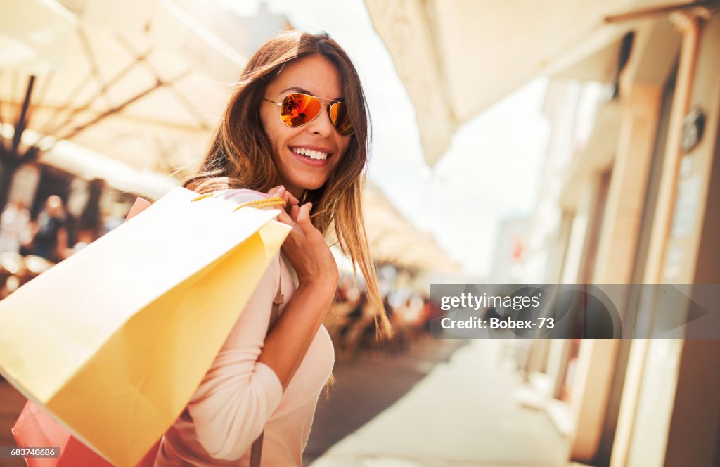 Shopping time. Young woman in shopping looking for presents. Consumerism, shopping, lifestyle concept