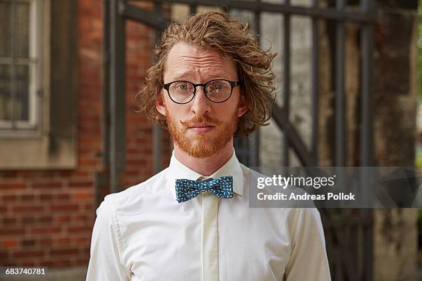 portrait of young man outdoors, wearing shirt and bow tie - bow tie stock-fotos und bilder