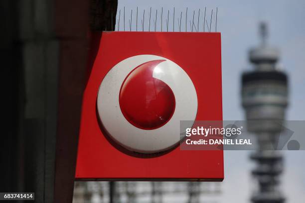 Vodafone logo is seen at a store in central London on May 16, 2017. - Vodafone logged today a large annual net loss after slashing the value of its...