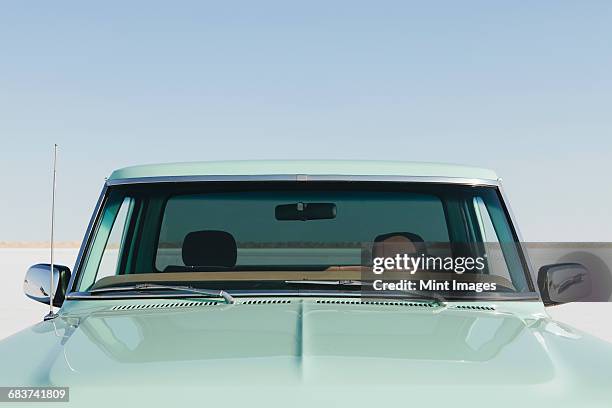 detail of a vintage ford f100 pickup truck, the windshield and hood. bonneville salt flats. - car hood stock pictures, royalty-free photos & images