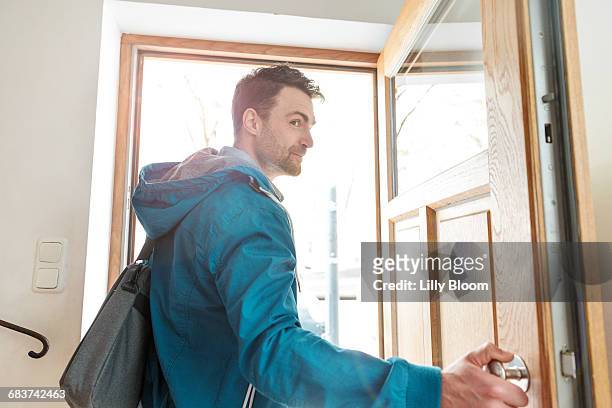 man leaving front door of house - leaving stock-fotos und bilder