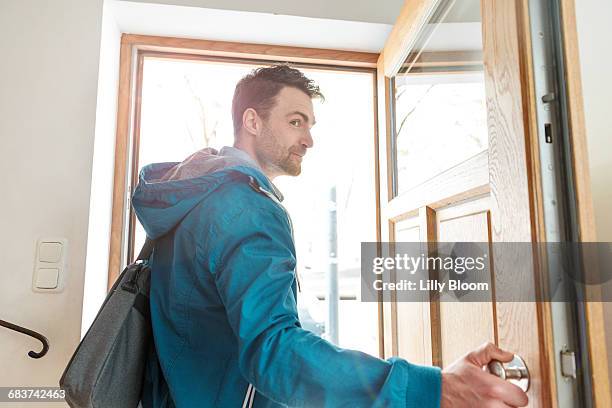 man leaving front door of house - walking away stock pictures, royalty-free photos & images