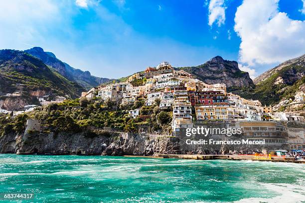 cliff side buildings by sea, positano, amalfi coast, italy - アマルフィ海岸 ストックフォトと画像