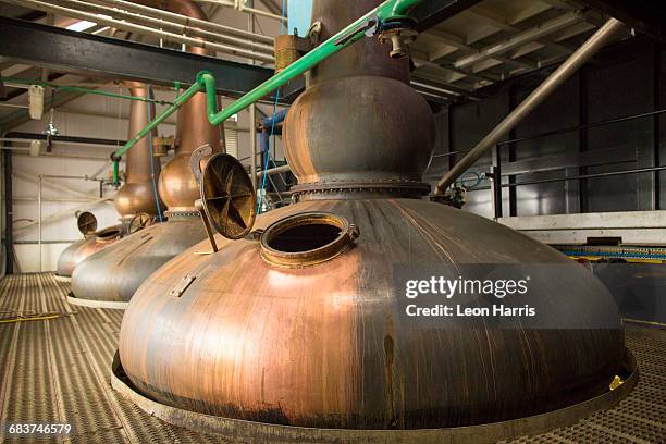 copper whisky stills in whisky distillery - scotland distillery stock pictures, royalty-free photos & images