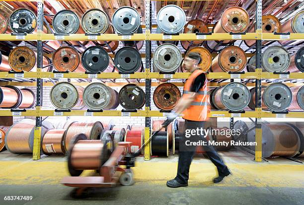 worker with copper cable reels in cable factory - spool stock pictures, royalty-free photos & images