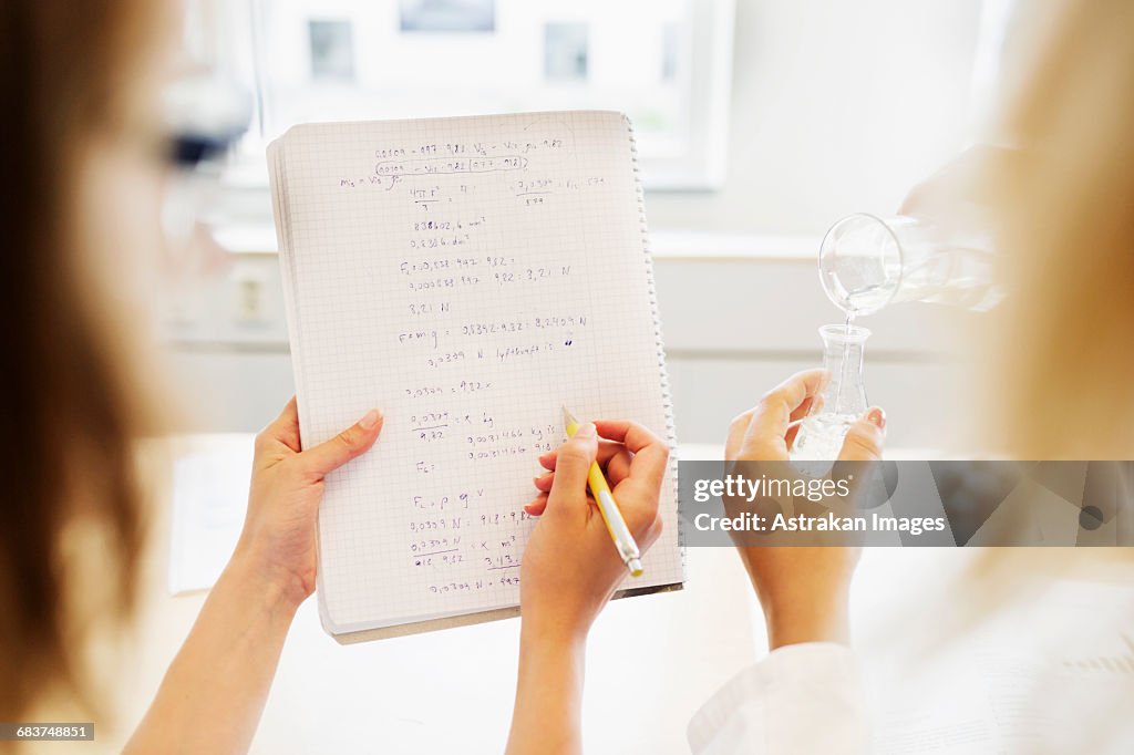 Students Analyze Cropped Image Of Female Students Analyzing Formulas While Performing ...