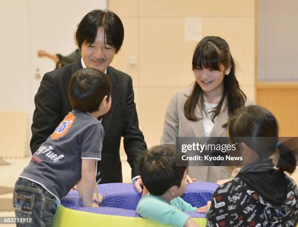 Photo taken in March 2014 shows Japan's Princess Mako , a granddaughter of Emperor Akihito, meeting children who lost their parents in the March 2011...