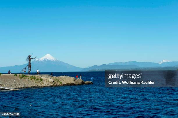 Metal sculpture at the waterfront of Puerto Varas with Lake Llanquihue and Mount Osorno in the Lake District near Puerto Montt, Chile.