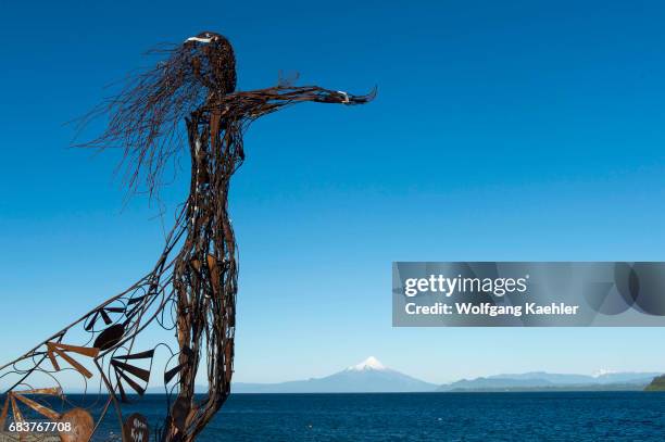 Metal sculpture at the waterfront of Puerto Varas with Lake Llanquihue and Mount Osorno in the Lake District near Puerto Montt, Chile.