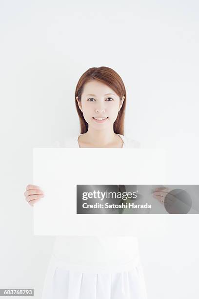 portrait of young woman - ボード　持つ　女性 ストックフォトと画像