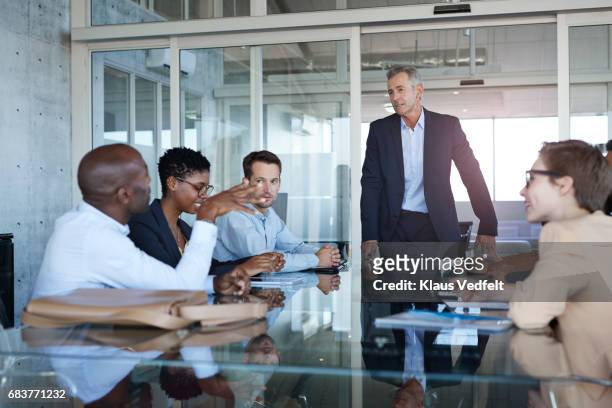 male ceo presenting plan in meeting room - chief executive officer stock pictures, royalty-free photos & images