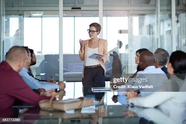 businesswoman presenting project in meeting room - businesswoman presenting stock pictures, royalty-free photos & images