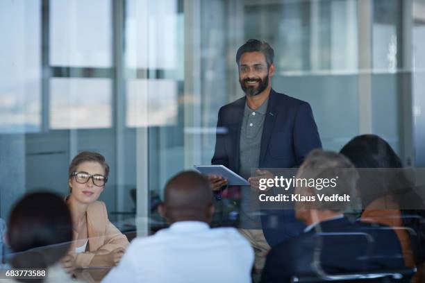 businessman presenting project in meeting room - ponencia fotografías e imágenes de stock