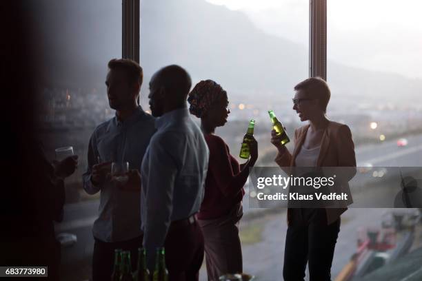 group of businesspeople having friday night drinks - talking friends backlight stock pictures, royalty-free photos & images