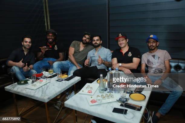 Cricketer Virat Kohli with his brother Vikas Kohli and Royal Challengers Bangalore teammates Chris Gayle, Shane Watson and Yuzvendra Chahal during...