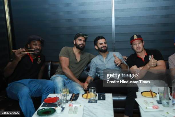 Cricketer Virat Kohli with his Royal Challengers Bangalore teammates Chris Gayle and Shane Watson during special dinner at his new restaurant Nueva,...