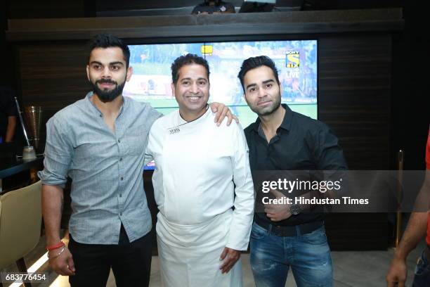 Virat Kohli and Vikas Kohli with Chef Michael Swamy during special dinner for Royal Challengers Bangalore teammates by Virat Kohli at his new...